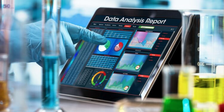 scientist working experiment with a computer in the laboratory / researcher working with data analysis report in digital tablet of the lab